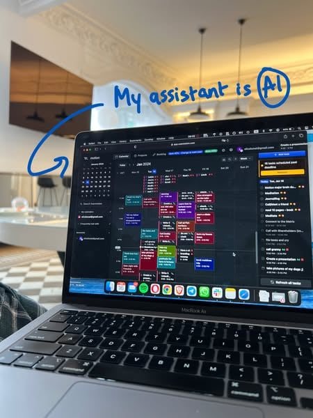 Motion's Meta ad: a MacBook on a lap in an apartment, with "My assistant is AI" handwritten in blue over the photo