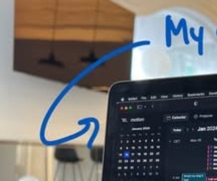 The hand-drawn arrow curving from the note down toward the laptop screen