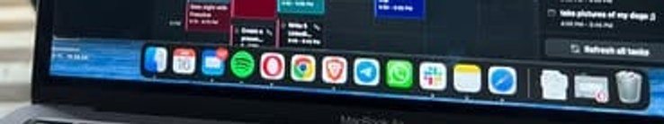 The real macOS dock visible at the bottom of the screen: Spotify, Chrome, Telegram, WhatsApp, Slack